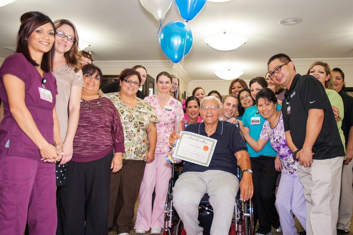 Staff celebrating with a resident