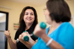 Therapist working with a resident in the gym