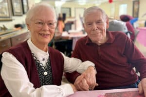 elderly couple holding hands at linwood meadows valentine's day lunch